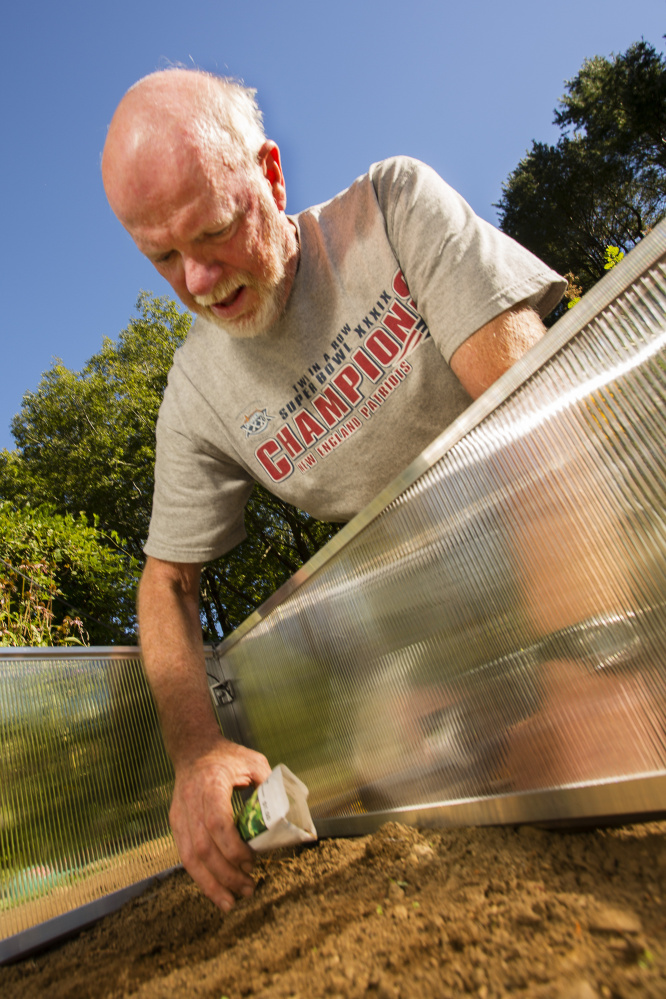 Tom Atwell plants carrots, lettuce and beets in a cold frame, a portable greenhouse that enables gardeners to extend the planting season.