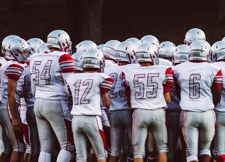 South Portland High School football players gather before their game Friday night in Sanford. One player was suspended Friday for what Superintendent Ken Kunin described as a hazing incident.
Whitney Hayward/Staff Photographer