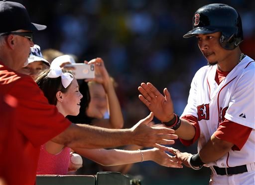 Red Sox center fielder Mookie Betts, right, is welcomed to the dugout after scoring on a sacrifice fly hit by David Ortiz in the second inning against the Philadelphia Phillies on Sunday. The Associated Press