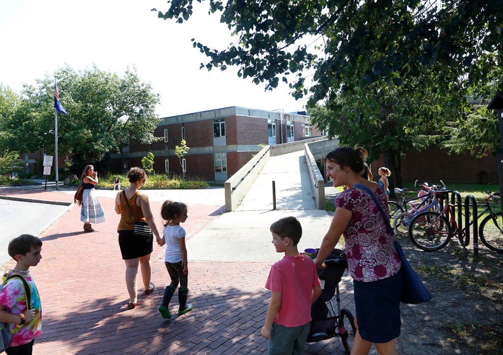 Kids and parents arrive at Portland's Reiche school at the start of last school year.   Reiche would be one of four elementary schools to get improvements under a borrowing plan backed by the school board.