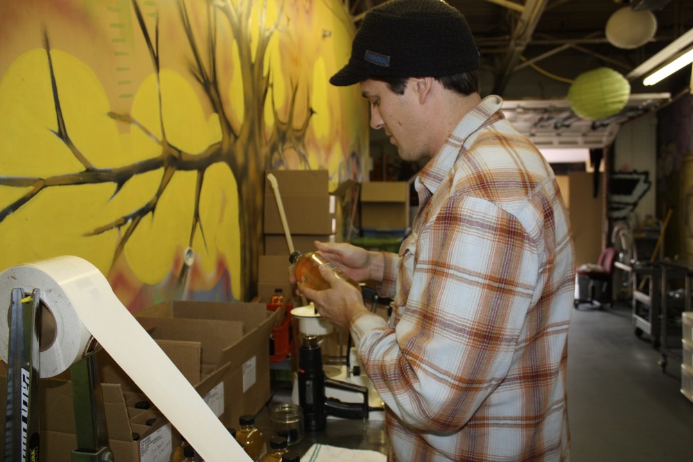 Reid Emmerich attaches a label to a bottle of Urban Farm Fermentory Kombucha Culture at the company's facility in Portland in this 2012 file photo. 