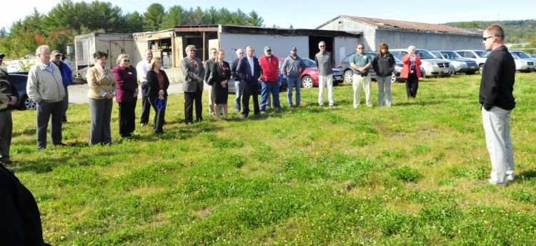 Standing on top of a containment hill filled with waste from the former Wilton Tannery, background, new owner John Black thanks the many supporters and agencies that assisted in the purchase and renovations at the site in Wilton on Thursday.