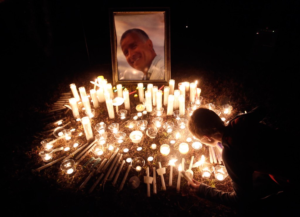 Anthony Boyd, 9, blows out a candle after a vigil Thursday night for Mike Davidson, the captain of the El Faro, in the neighborhood where his family lives in Windham. Davidson was among 33 crew members on the ship when it sank in Hurricane Joaquin.
Derek Davis/Staff Photographer