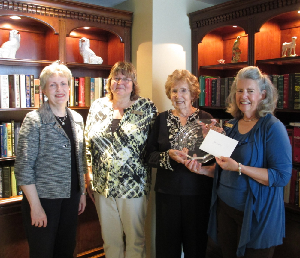 Scarborough Public Library director Nancy Crowell, left, Scarborough Terrace executive director Judy Cox, volunteer book mender June Cassidy and Scarborough Terrace marketing director Elizabeth Simonds at the recent presentation of the Senior Service Award to Cassidy. She has repaired more than 7,000 library books since 1996.
