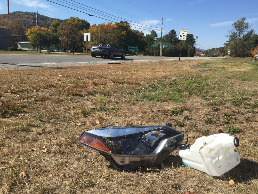 Debris from the accident that killed Paul Stucki remained on the side of Route 2 in Dixfield on Monday.