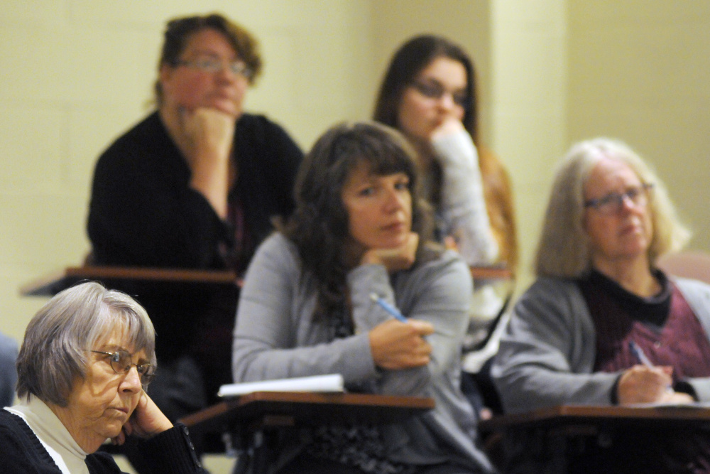 People listen to a discussion Tuesday at City Center in Augusta about combating childhood hunger and homelessness.