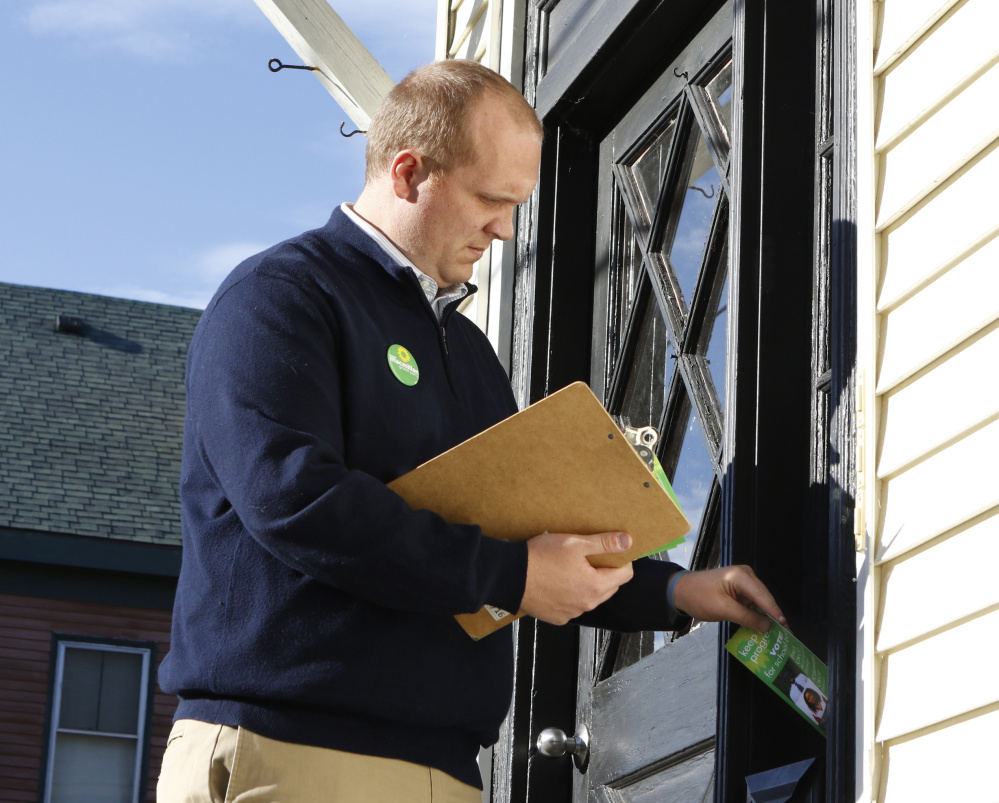 Portland mayoral candidate Tom MacMillan distributes campaign literature on Munjoy Hill. “People are sick and tired of the status quo,” MacMillan says.