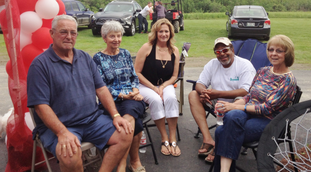 Dan Alexander, left, is shown visiting friends at a graduation party.