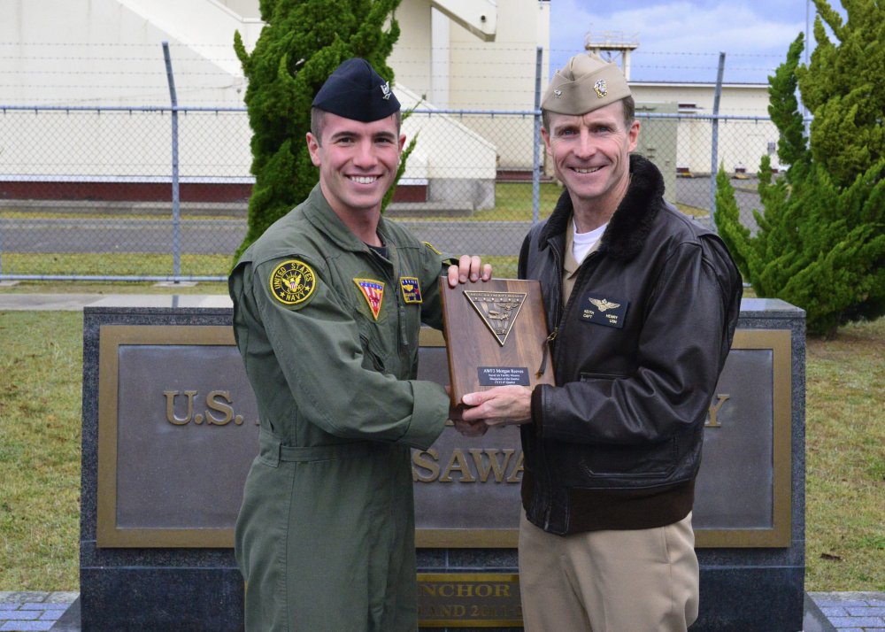 Aircrewman 3rd Class Morgan Reeves, left, of Lisbon receives the Blue Jacket of the Quarter award from Capt. Keith Henry in Misawa, Japan.