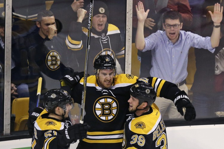 Bruins right wing Jimmy Hayes, center, celebrates after his goal in the second period Tuesday night against the Arizona Coyotes. The Bruins rolled to a 6-0 win.