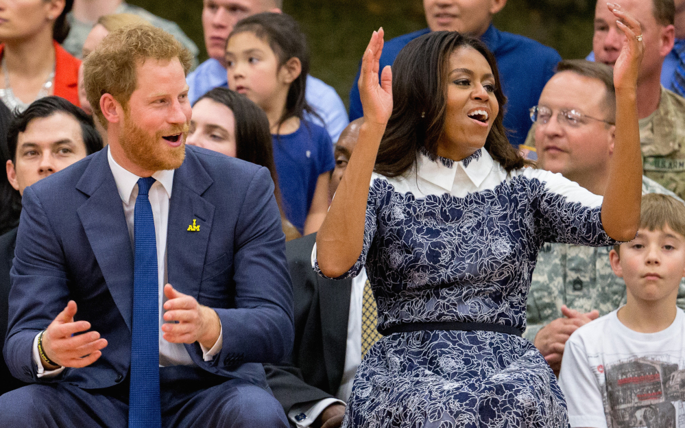 Britain’s Prince Harry and first lady Michelle Obama watch wounded servicemen and veterans play wheelchair basketball Wednesday in Fort Belvoir, Va.
