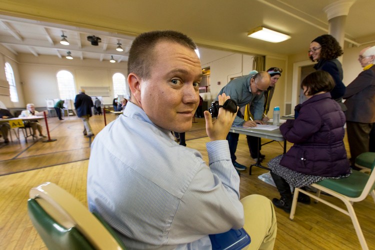 Shane Belanger, a volunteer with the Project Dirigo group, videotapes a voter signing a petition in Portland on Nov. 3. Sen. Bill Diamond of Windham wants lawmakers to consider a bill designed to ensure that video recording at polling places doesn’t intimidate voters.