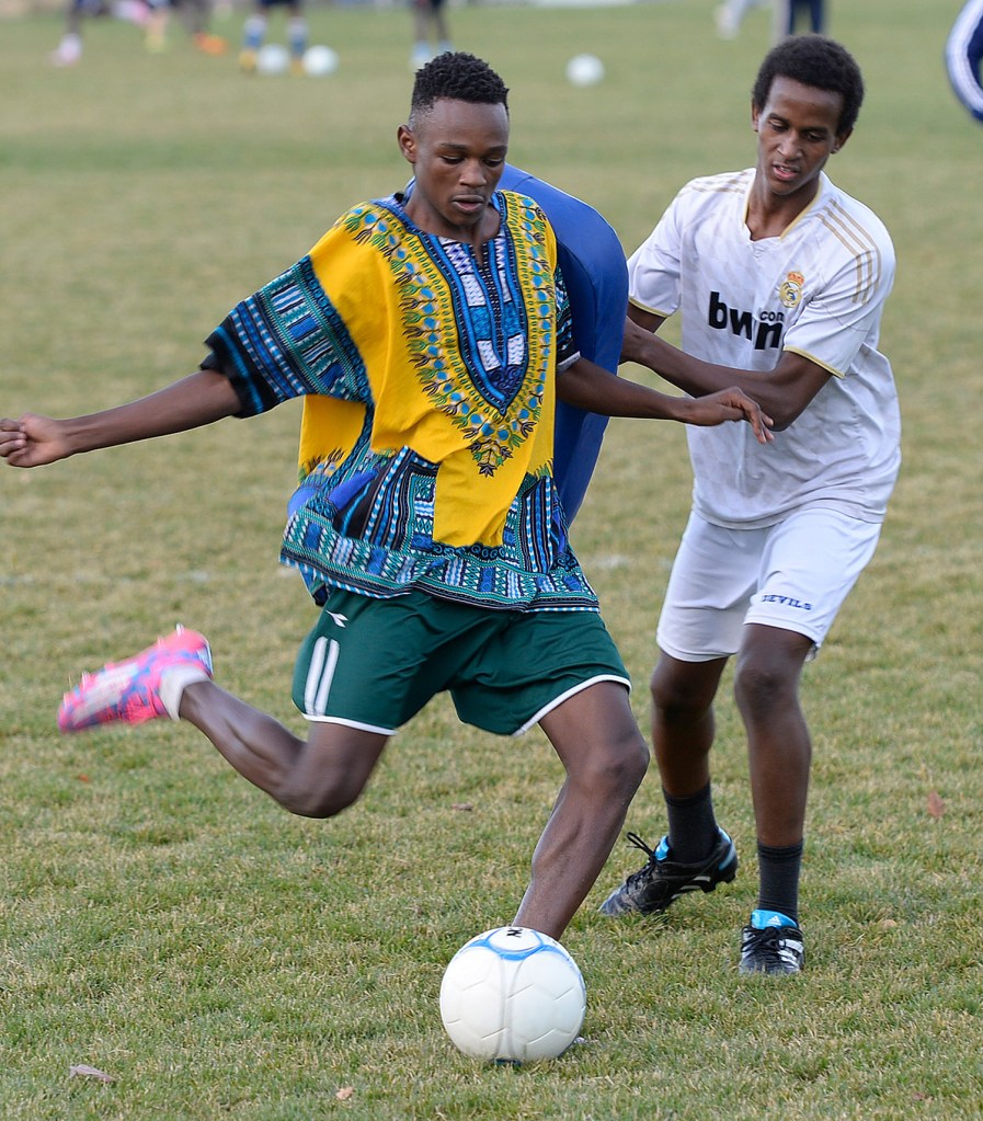 Abdirizak Ali, left, attempts a shot as his teammate Dek Hassan tries to interrupt him during drills at practice in 2015. Hassan said he and seven of his teammates grew up in the same refugee camp. A book about the team has been optioned by Netflix.