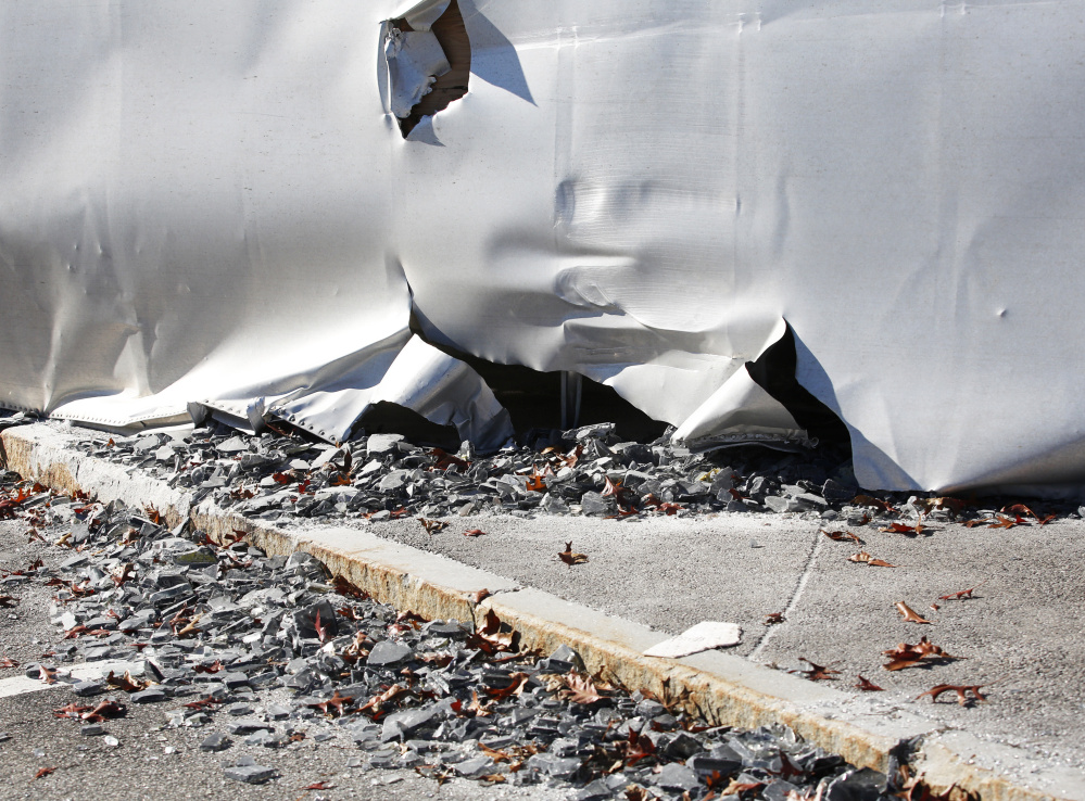 Pieces of thick glass spilled when a tractor-trailer overturned at the northbound service plaza off the Maine Turnpike in Kennebunk on Monday.