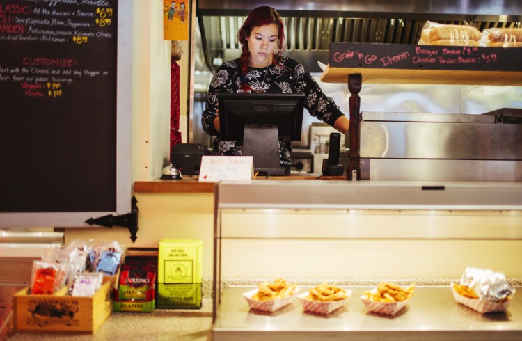 Ambre Davidson works at Hilltop Superette in Portland, where she is paid about $10 an hour. She said she voted Tuesday in favor of a $15 minimum wage, but thinks $12 an hour is more likely to pass. It would make “a huge impact” on her finances, she said.