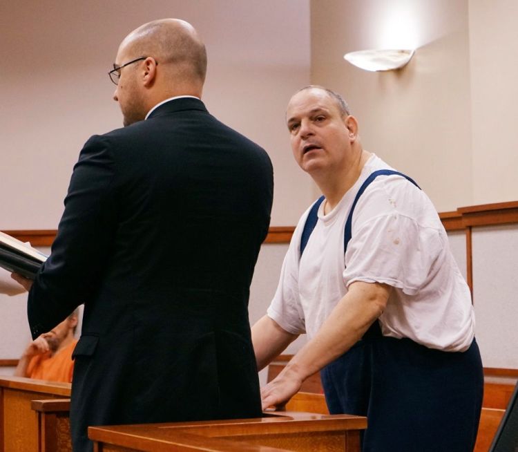 Steven Ricci, right, with his attorney, Mark Bullock, accepts new probation conditions in advance of his release from prison, in the Cumberland County Courthouse in Portland on Thursday. Photo by Scott Dolan/Staff Writer