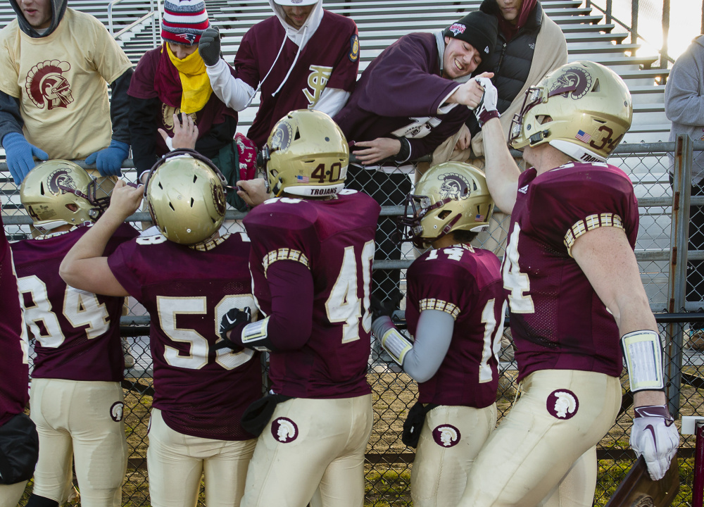 Thornton Academy players celebrate with fans after beating Bonny Eagle for the Class A South title Saturday in Saco. Carl D. Walsh/Staff Photographer