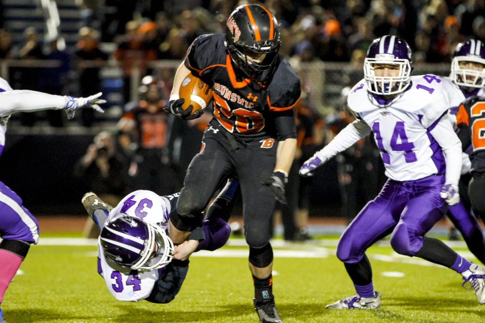 Marshwood sophomore Matthew Goodwin takes down Brunswick junior Hunter Garrett during the Class B state final Saturday at Fitzpatrick Stadium. Ben McCanna/Staff Photographer