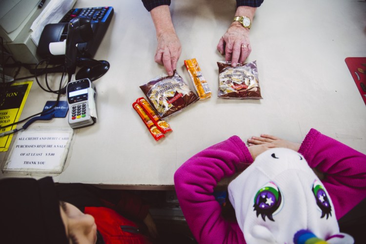 Clerk Jim Wickham checks out customers at Mellen Street Market in Portland on Monday. A new state proposal is asking for a federal waiver to allow the department to ban purchase of junk food with food stamps.