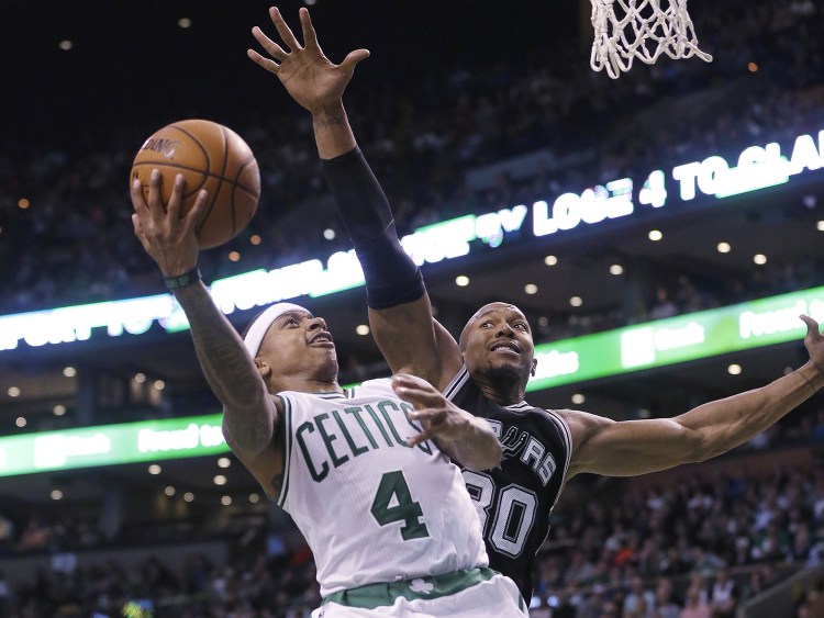 Celtics guard Isaiah Thomas takes a shot at the basket as Spurs forward David West tries to block him in the third quarter Sunday in Boston. The Spurs won 95-87. The Associated Press