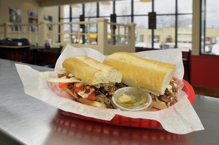 Gordon Chibroski/Staff Photographer
The signature sandwich at Po'Boys & Pickles features roast beef, gravy, lettuce, tomato and horseradish mayo.