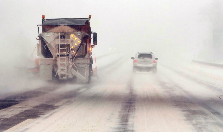 A snow plow clears a northbound lane of the Maine Turnpike in Scarborough during southern Maine's first winter storm in December.