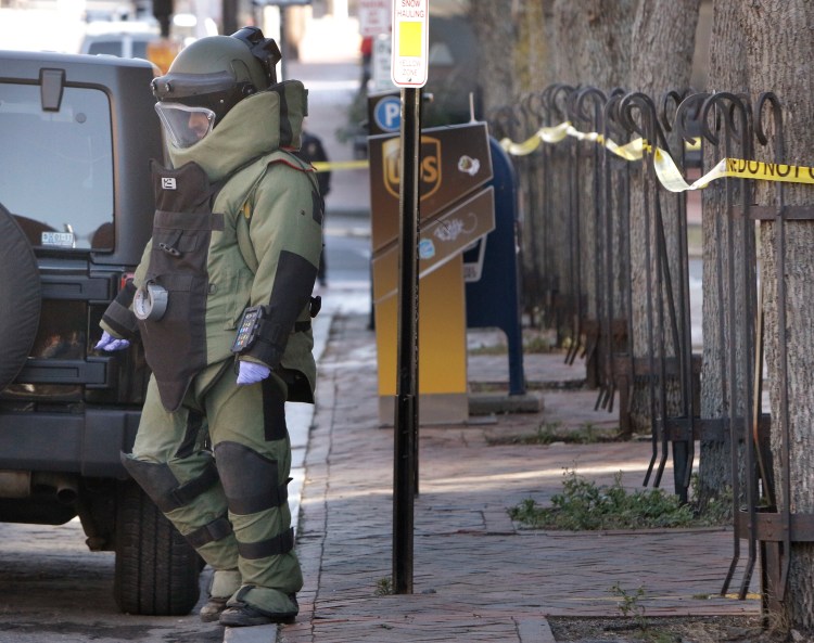 A member of the Portland police bomb squad returns to Middle Street while investigating a suspicious package that was found at 100 Middle St. on Monday. Police Chief Michael Sauschuck said police cleared the package from the building, which houses the FBI regional office and the U.S. Attorney's Office. 
Gregory Rec/Staff Photographer