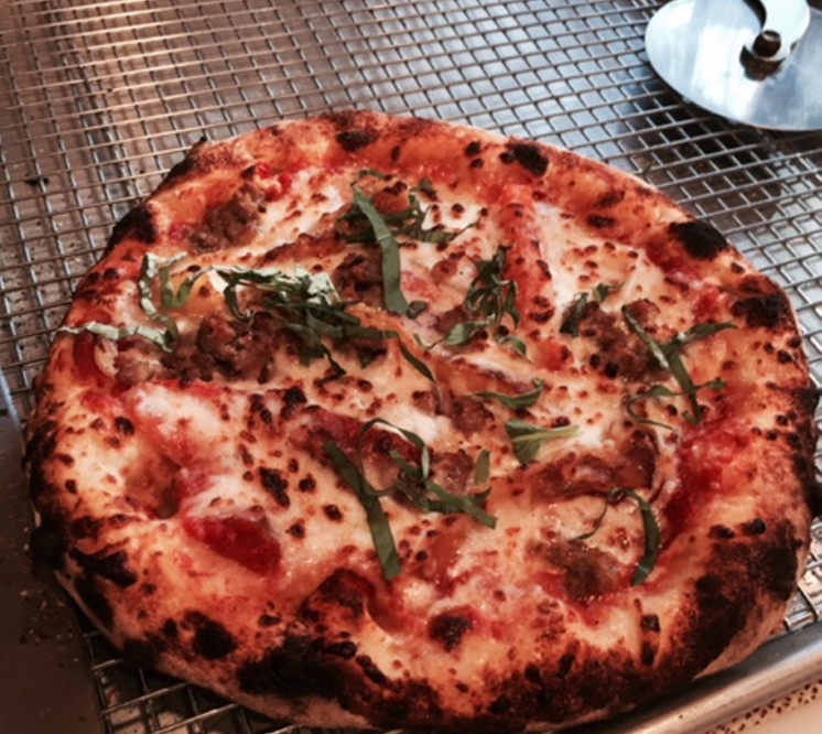 Students at Stone Turtle's  Rustic Artisan Bread Class lunch on wood-fired pizzas they make themselves.