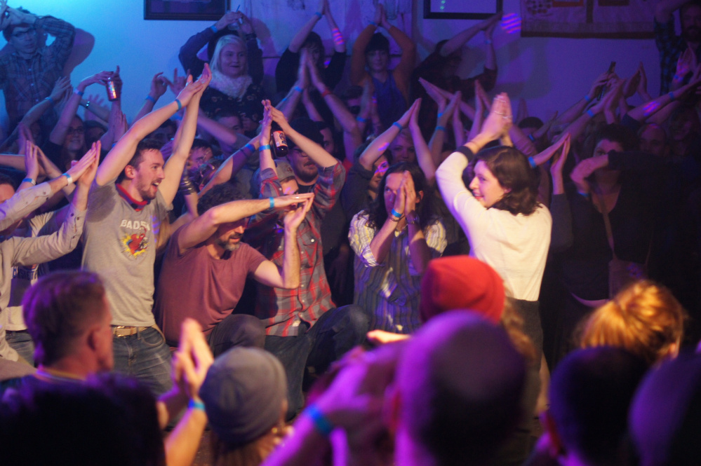 An audience member directs the crowd in a game of follow the leader.