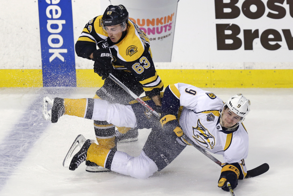 Bruins left wing Brad Marchand drops Nashville Predators center Filip Forsberg to the ice in the first period Monday night in Boston. The Predators beat Boston, 3-2.