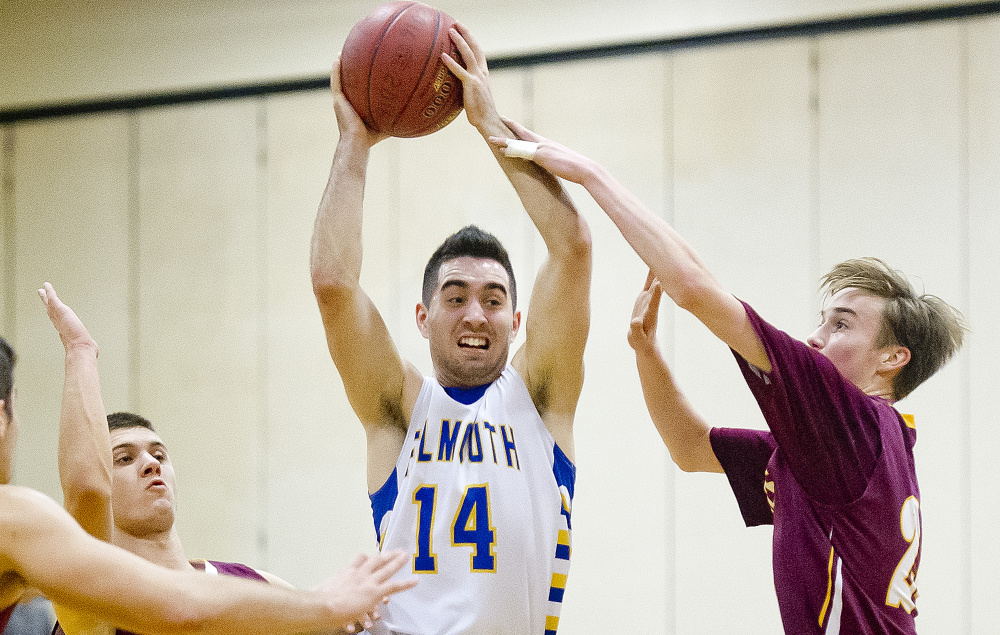 Thomas Coyne of Falmouth splits Cape Elizabeth defenders Jack O’Rourke, left, and Finn Bowe in boys’ basketball game Tuesday night at Falmouth. Coyne scored 35 points in the Yachtsmen’s 69-66 win.