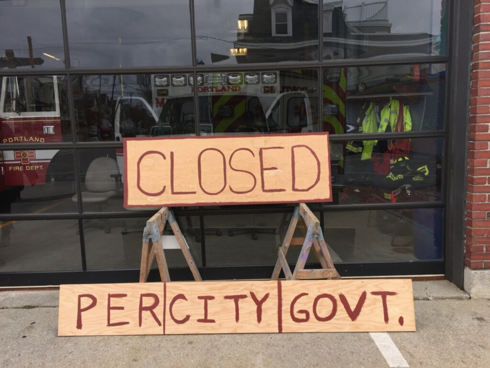 Contrary to the sign, the Munjoy Hill fire station has not closed; its ambulance is sometimes taken out of service during the overnight hours, when call volumes are lowest, in order to rein in overtime costs.