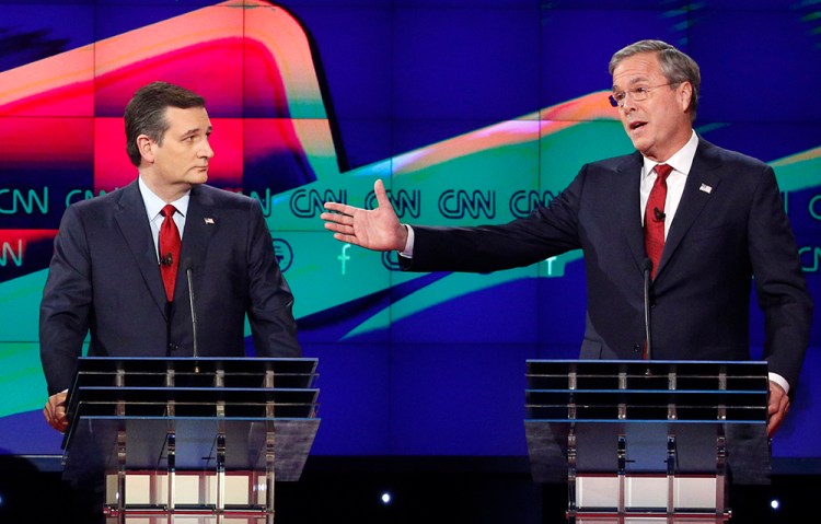 Jeb Bush makes a point as Ted Cruz watches during a CNN Republican presidential debate in December. The Associated Press