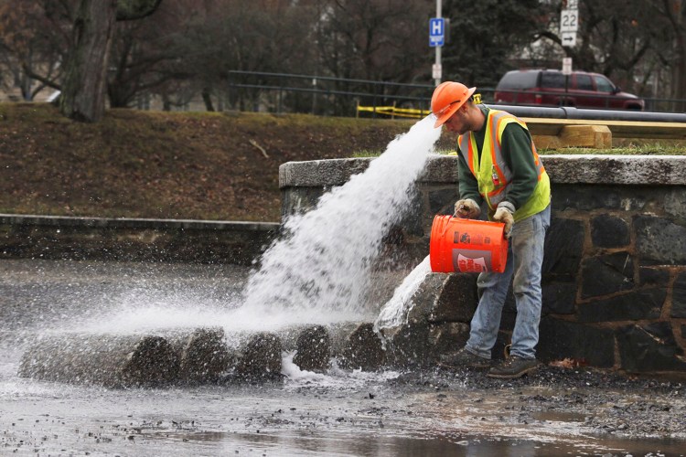 Garrett Pingree of R.J. Grondin & Sons works on repairs that are part of the renovation of the pond in Deering Oaks park in Portland on Friday.