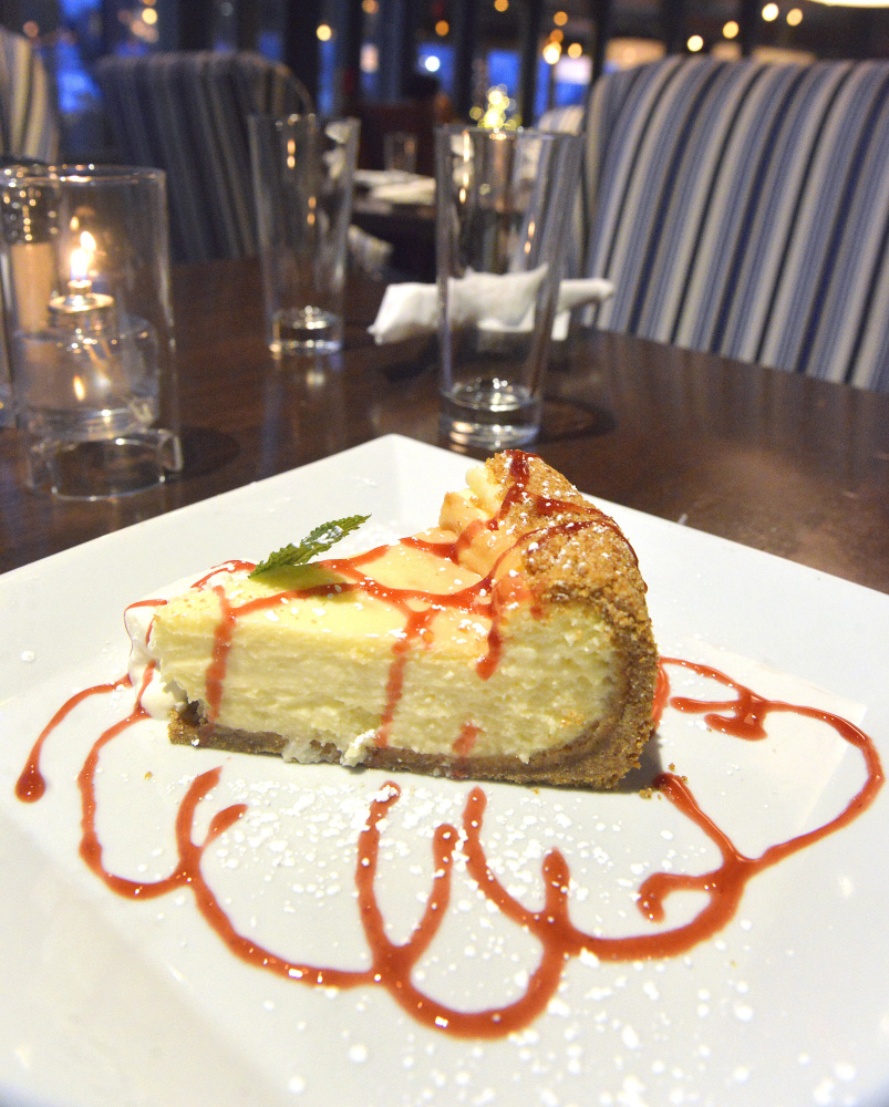 New York-style cheesecake with graham cracker crust and raspberry coulis.