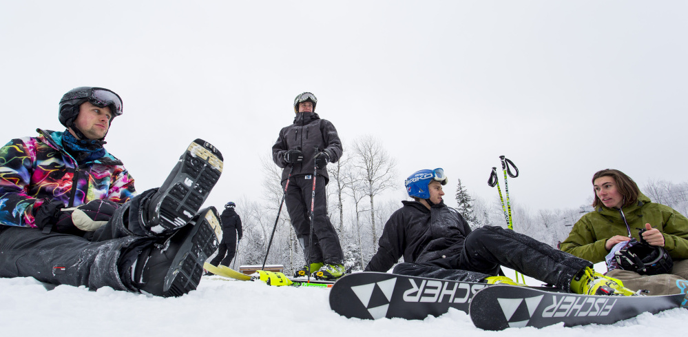 From left, Luke Wenzel, of Boston, Sean Daigle, Alex Daigle, and Toby Smith, all of Manchester, take a break at Sugarloaf. The group said that even though Saddleback Mountain is still closed this season, it hasn’t affected them much since they hold passes to Sugarloaf. 