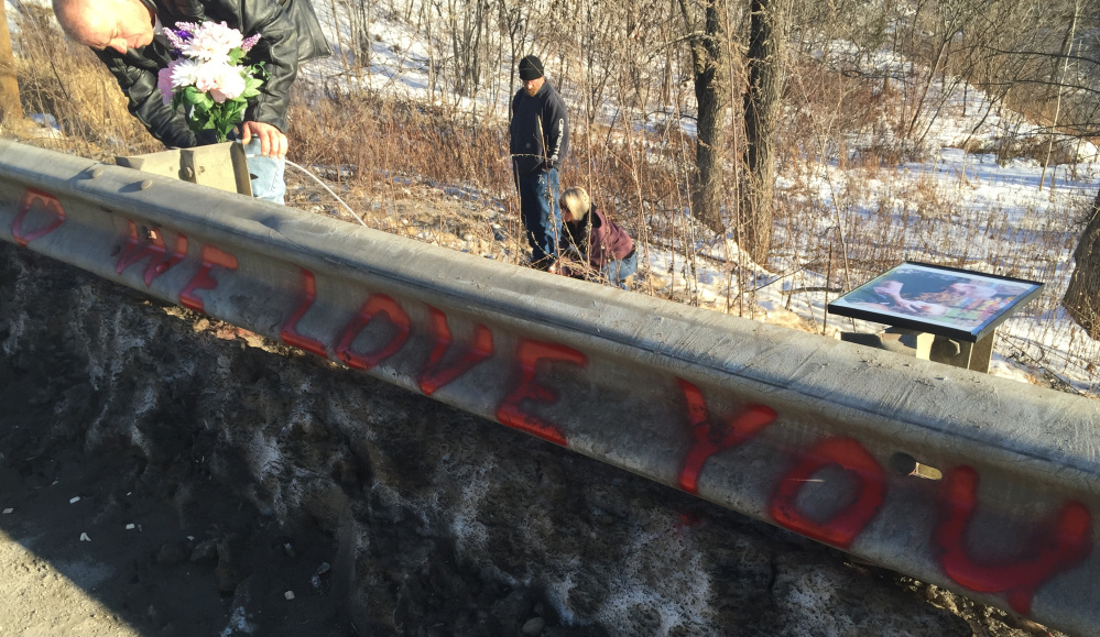 Ricky Gaboury secures flowers to a memorial Thursday at the spot where his daughter, Taylor Gaboury, was killed by an alleged drunk driver on New Year’s Day in Farmington.