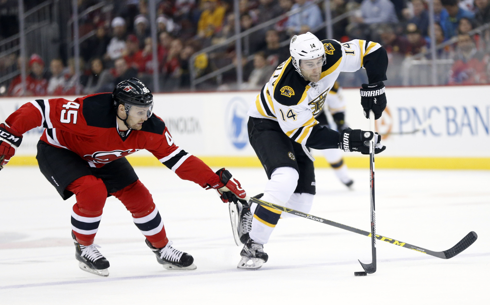 Devils right wing Paul Thompson defends against Bruins right wing Brett Connolly in the first period of Friday night’s game,.
