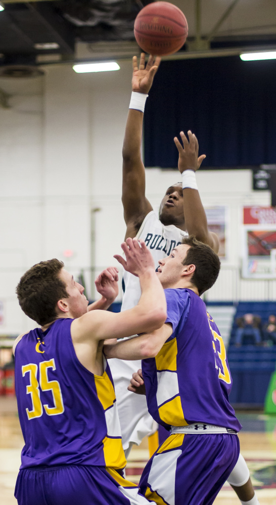 Amir Moss, who scored a game-high 18 points for Portland, soars for a jump shot over the Cheverus defense. The Bulldogs, executing their offense well, hit 68 percent of their shots in the deciding first half.