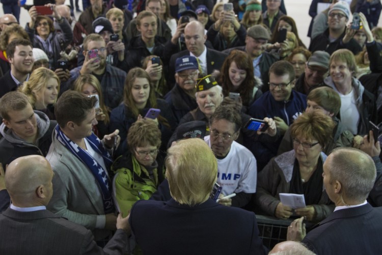 Republican presidential candidate Donald Trump shakes hands with an overflow crowd after a campaign rally at Dordt College, on Saturday in Sioux Center, Iowa.