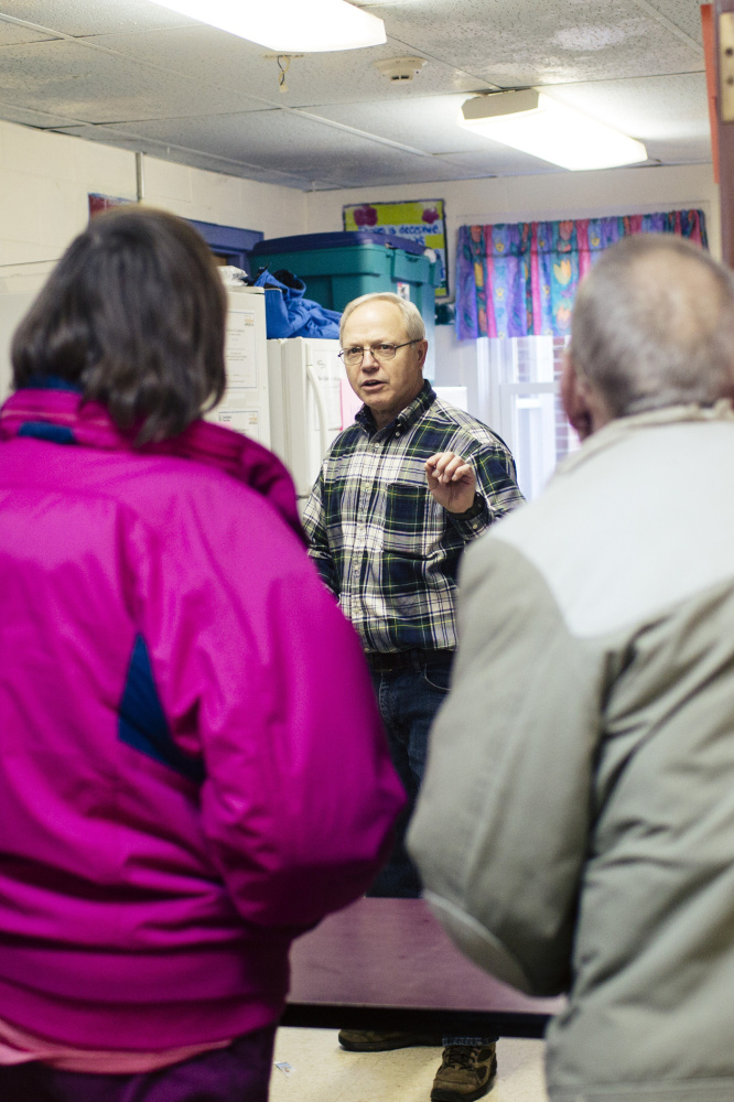 Doug Horner asks Elizabeth and Kevin Leonard what kind of meat they would like at the Stroudwater Christian Church food pantry in Portland.