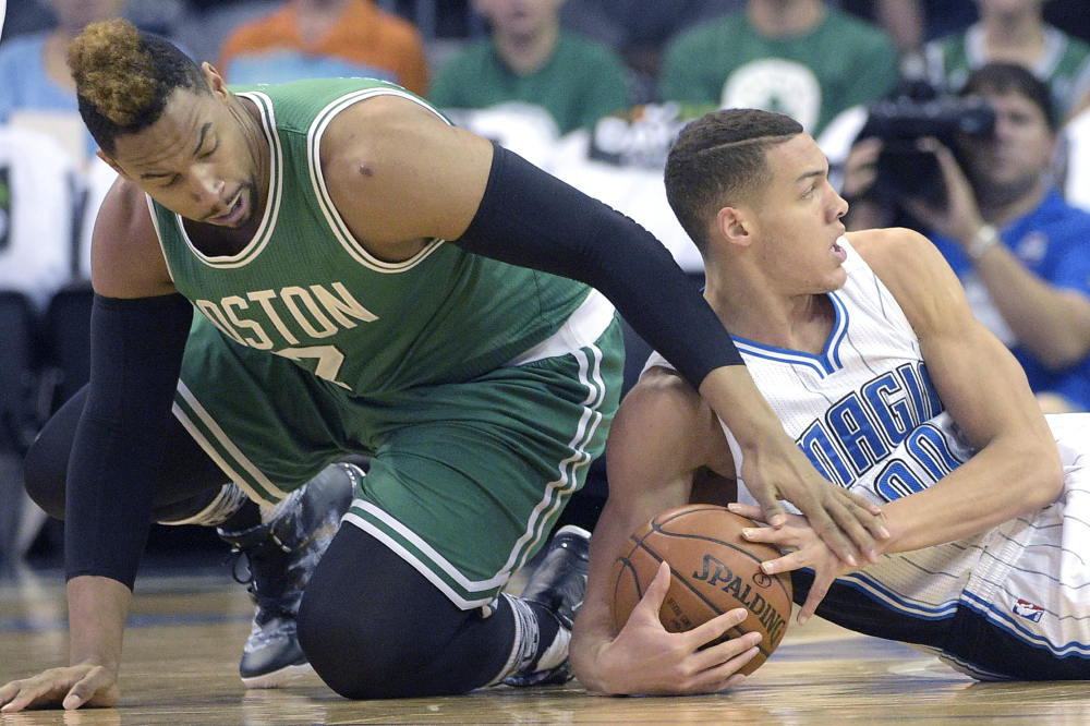 Celtics center Jared Sullinger, left, and Orlando forward Aaron Gordon battle for a loose ball during the Magic’s 119-114 win Sunday in Orlando.
