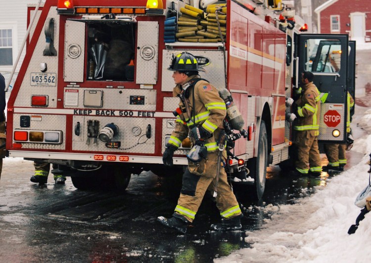 Firefighters at the scene of a fire at 14 River St. in Westbrook. Whitney Hayward/Staff Photographer