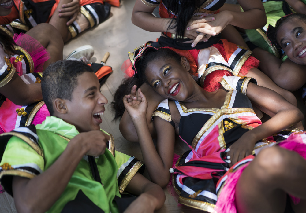 Young revelers joke with each other as they lay in the shade during a carnival event in Brazil. Scientists said Friday that they found the presence of Zika virus in saliva and urine samples, which means the disease could be spread by more than just mosquitoes.