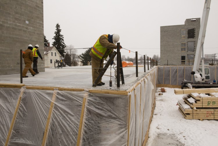 Contractors work on a new building on Anderson Street in Portland in February. The city has approved a plan to speed up its process of issuing building permits.
Carl D. Walsh/Staff Photographer