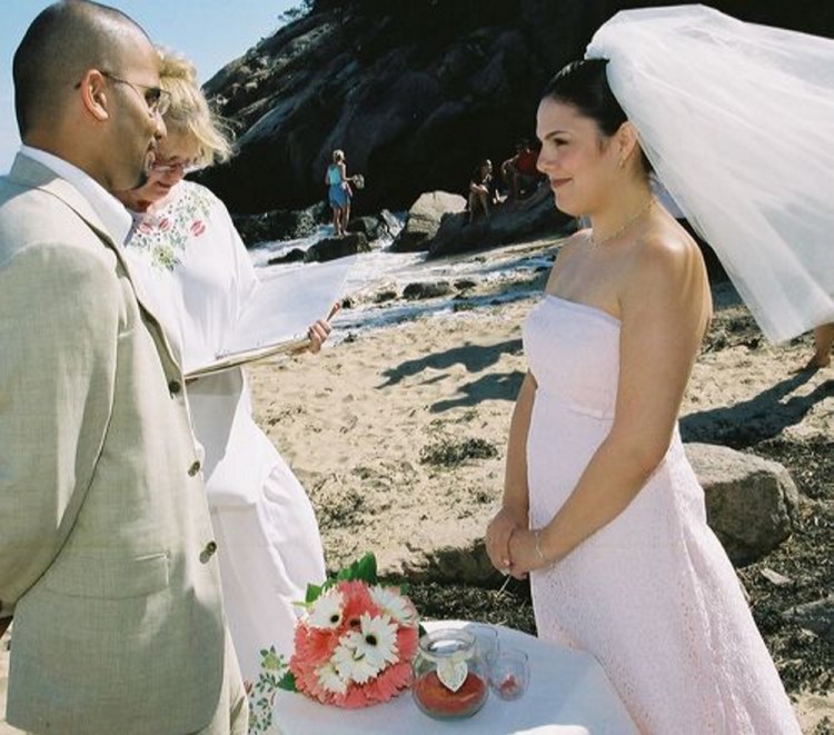 A couple marries at Acadia National Park, sharing the setting with several beachgoers (background).