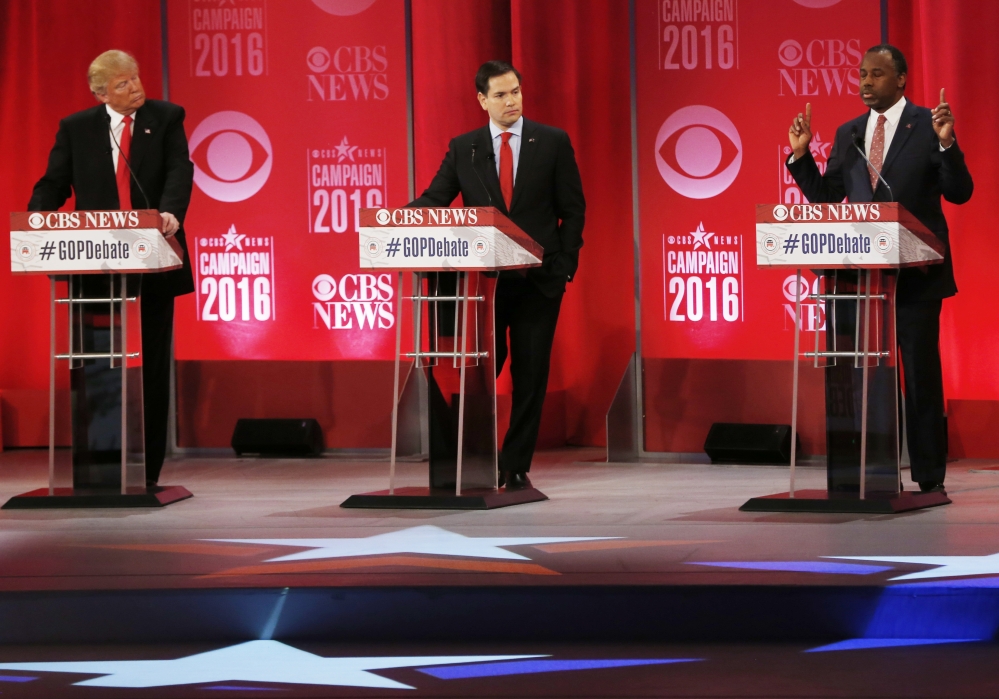 Retired neurosurgeon Ben Carson, right, speaks as Donald Trump and Sen. Marco Rubio, R-Fla., look on during the CBS News Republican presidential debate at the Peace Center on Saturday in Greenville, S.C.