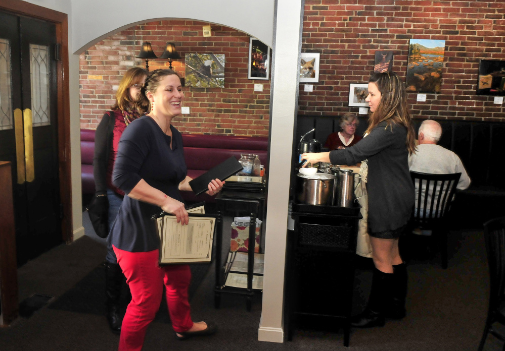 Amy Ouellette, co-owner of The Last Unicorn restaurant in Waterville, greets a customer in the new entrance foyer on Friday. The restaurant recently reopened after being closed for 10 days for renovations.