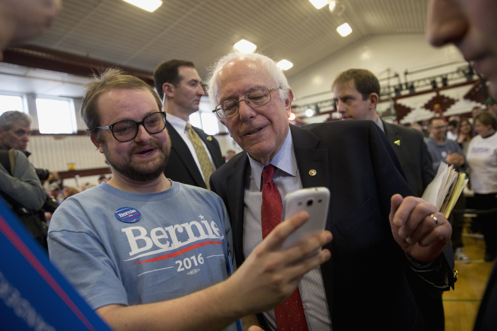 Democratic presidential candidate Sen. Bernie Sanders, I-Vt., pauses for a photo with a supporter at a rally Friday in Elko, Nevada.