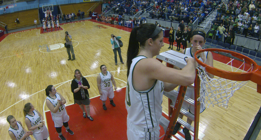 Joe Phelan/Kennebec Journal
Rangeley senior center Blayke Morin, middle, cuts down a net after the Lakers beat Vinalhaven in the Class D South championship game Saturday at the Augusta Civic Center. Teammate Natasha Haley is also on top of ladder.